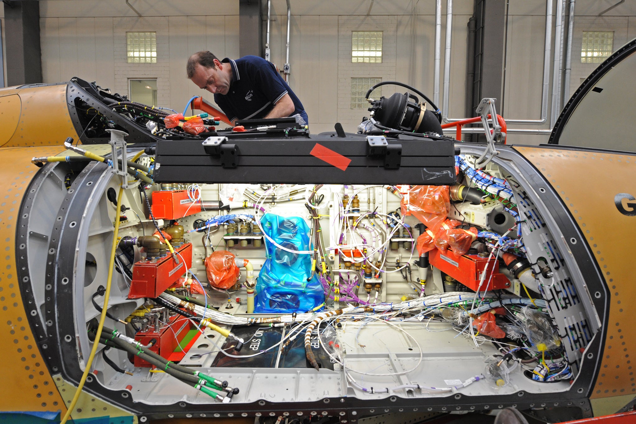 Military aircraft maintainer installing microwave able assemblies.