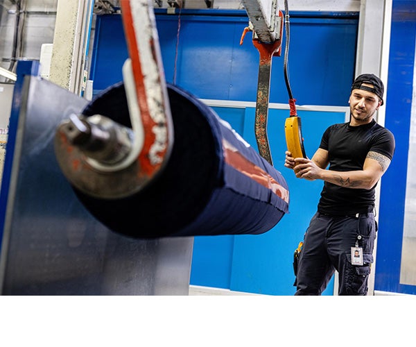 An Associate working with a role of laminate